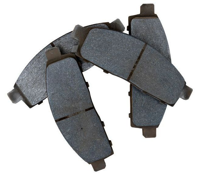 Three brake pads are stacked on top of each other on a white background