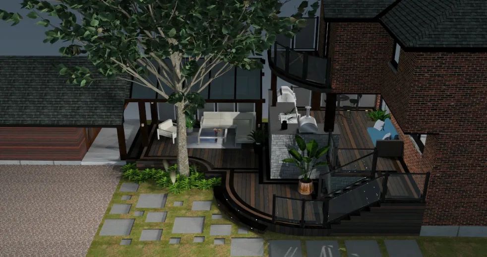 A high-angle view of a backyard deck with seating areas, a glass-railed staircase, and a large tree, beside a brick house.