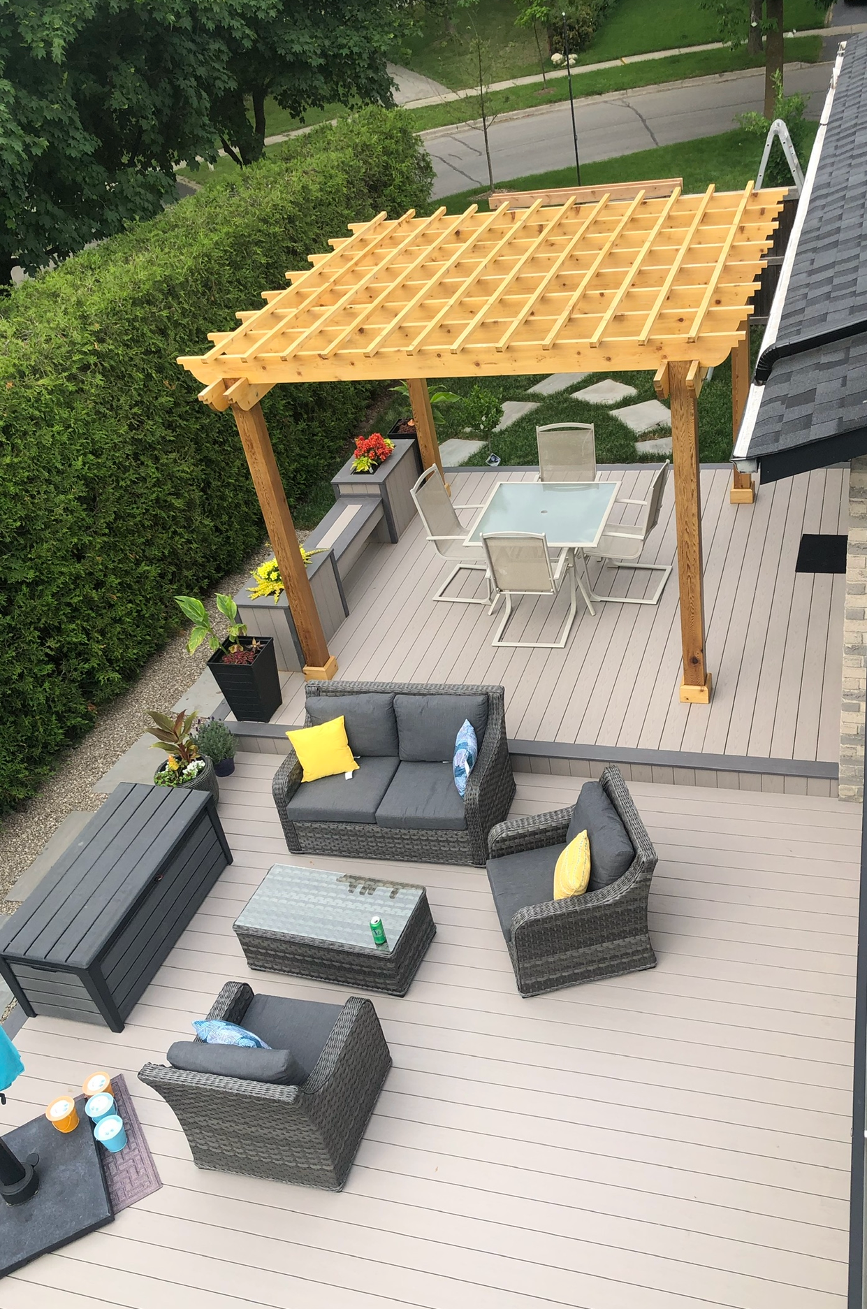 An aerial view of a patio with a pergola and patio furniture.