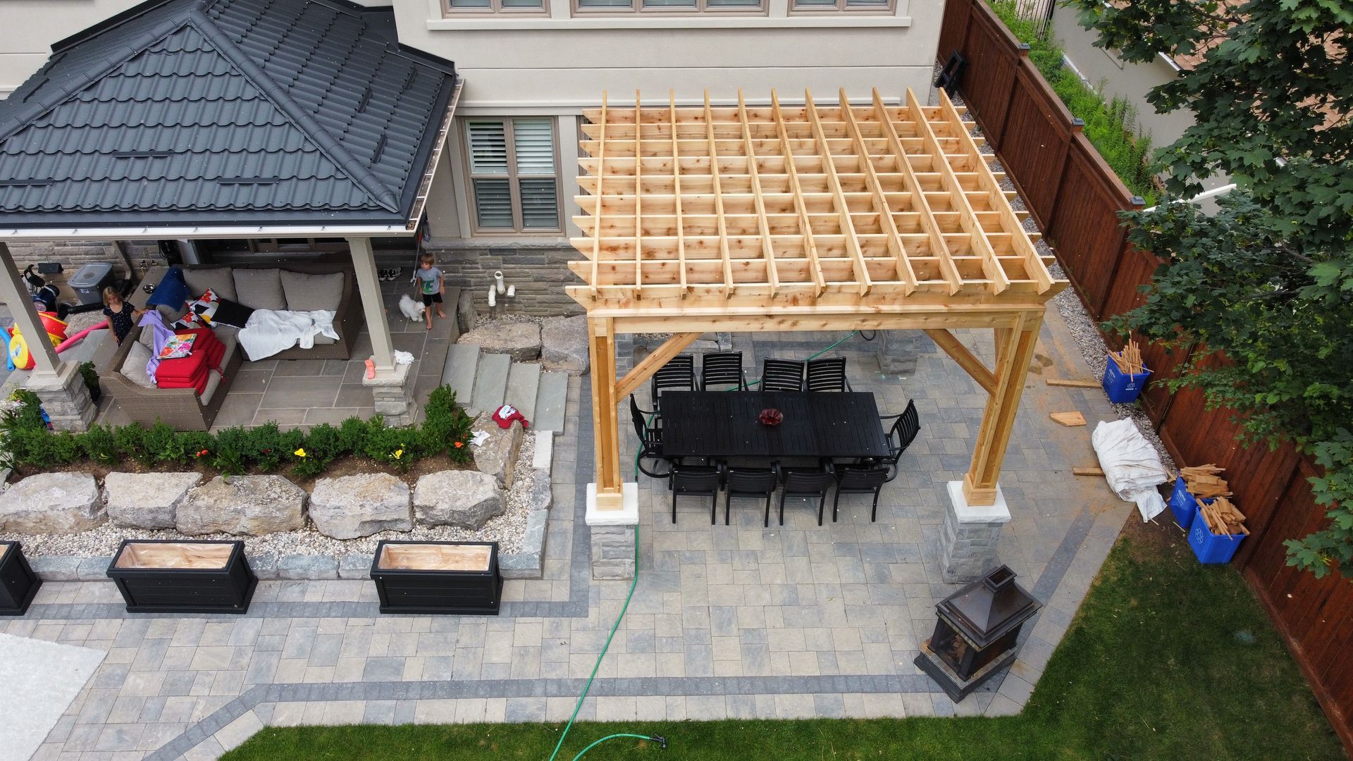 Large patio area with gazebo, pergola, and outdoor dining set.