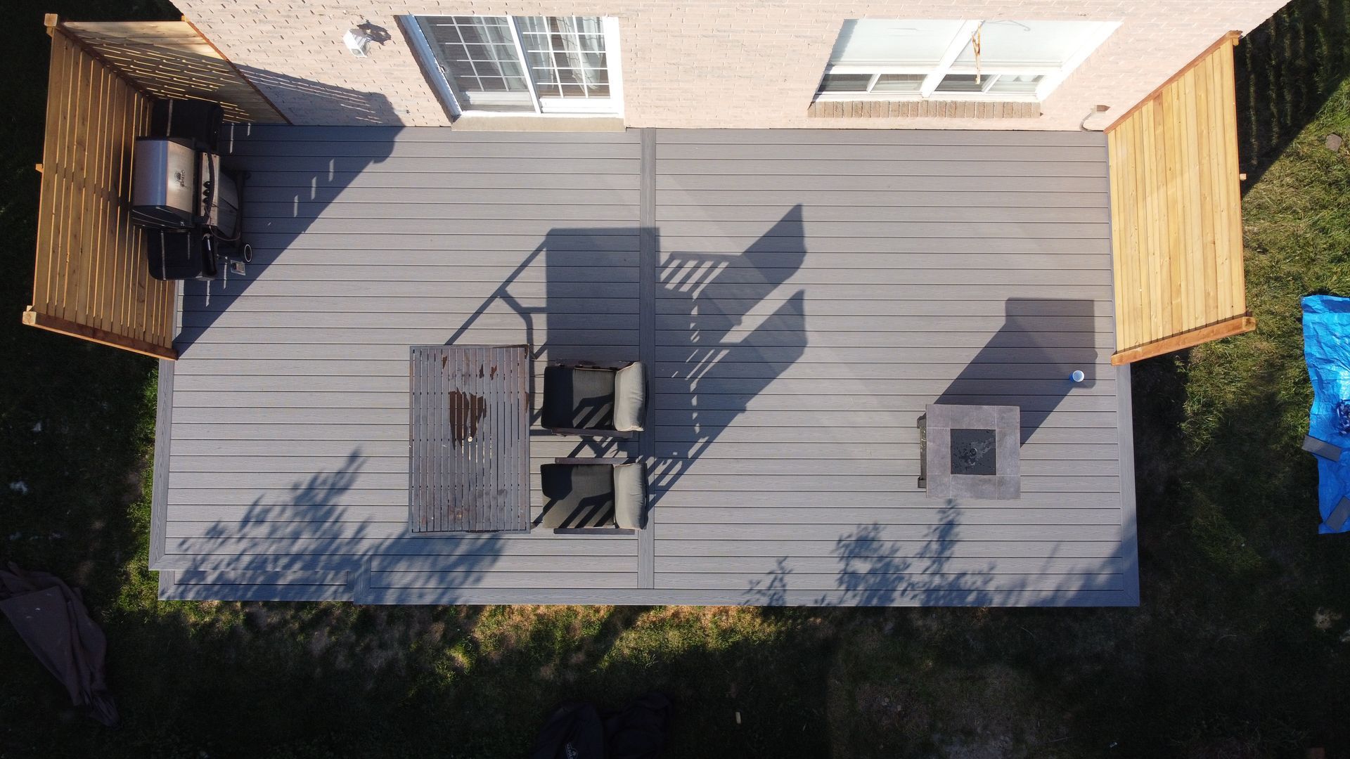 An aerial view of a deck with a table and chairs