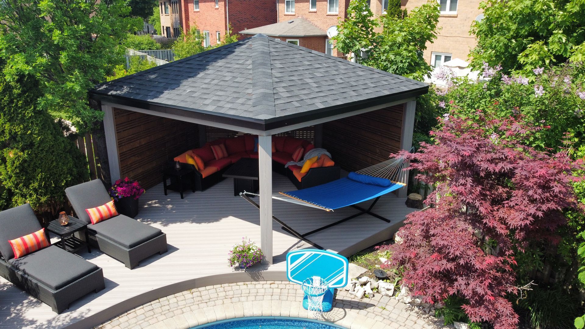 An aerial view of a backyard with a gazebo and a pool.