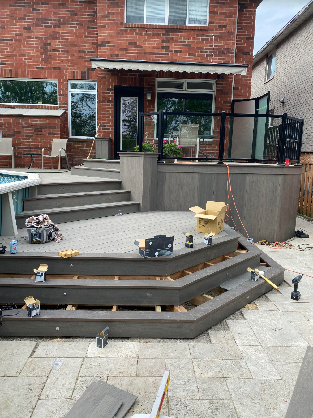 A man is working on a wooden deck.