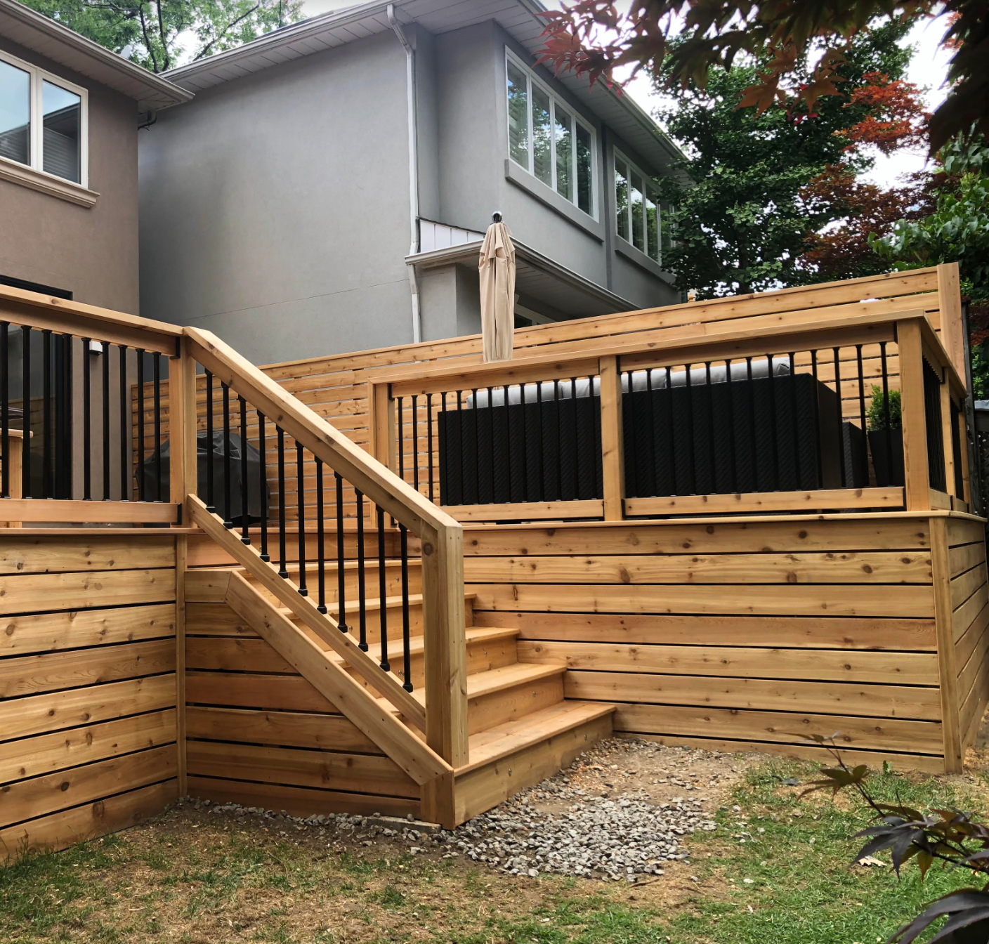 The back of a house with a large deck and stairs