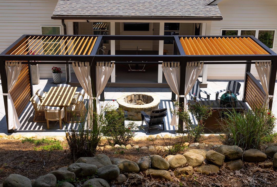 An aerial view of a patio with a pergola and a fire pit.