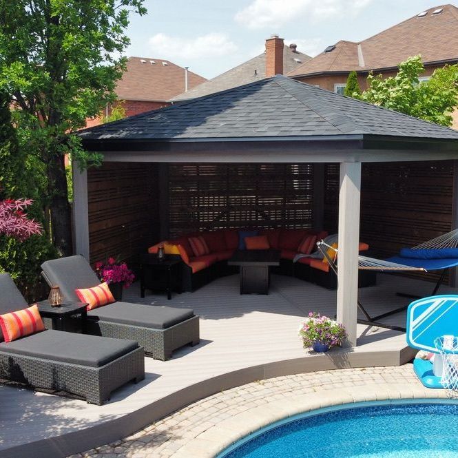 A patio with a gazebo and chairs next to a pool