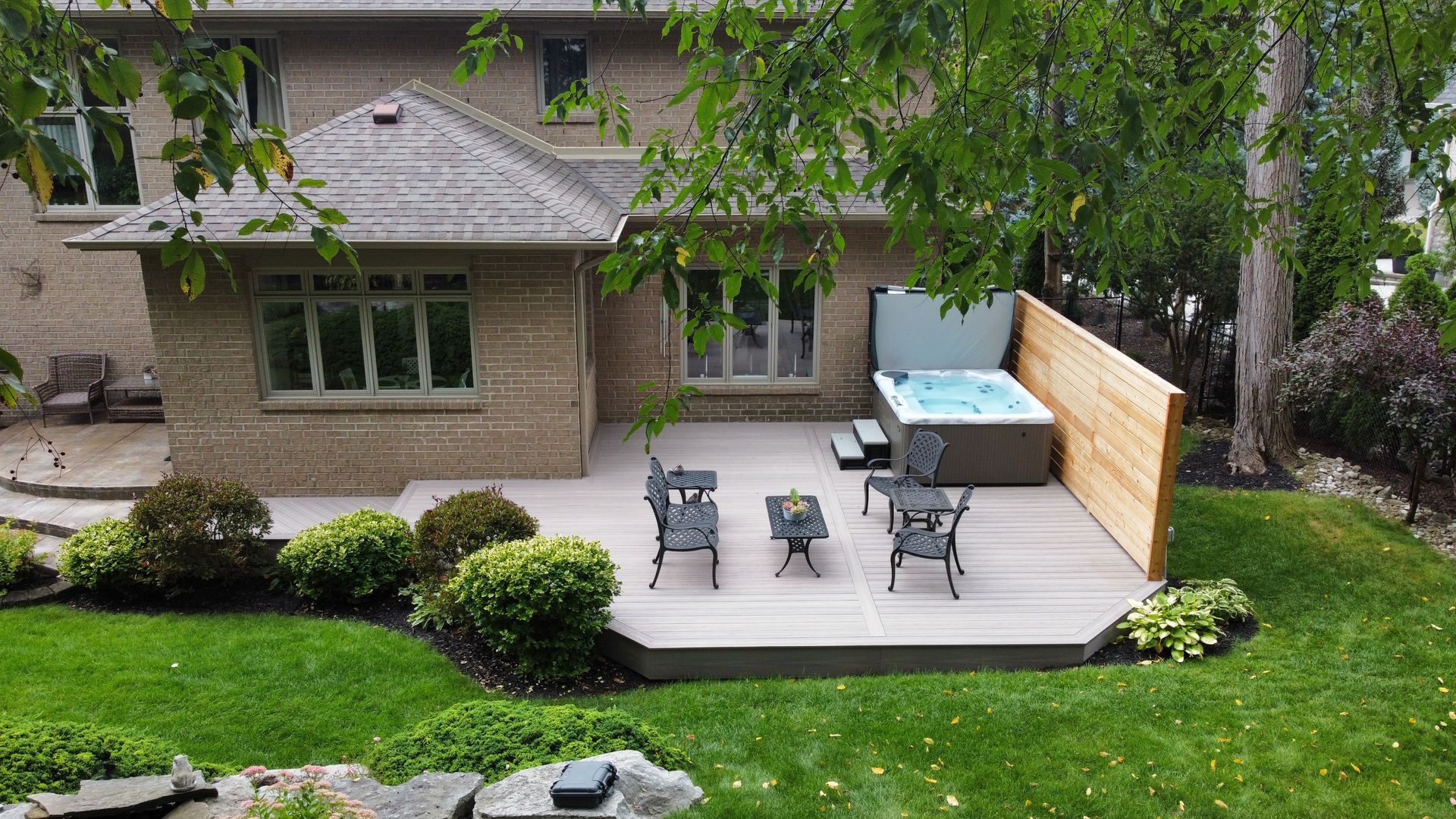 An aerial view of a house with a hot tub in the backyard.