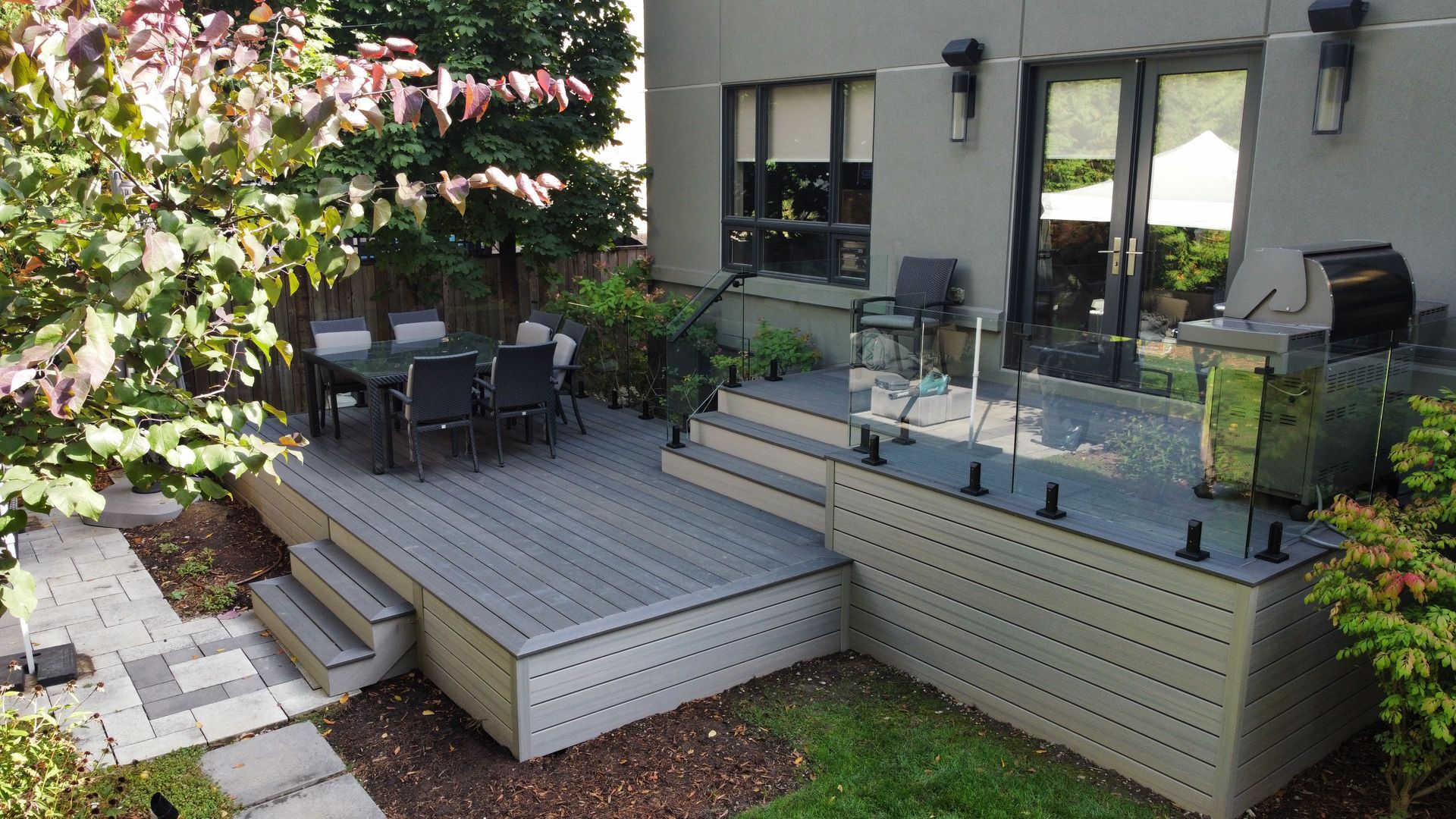 A large deck with a table and chairs on it