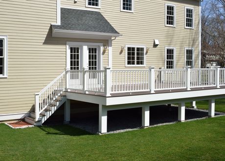 The back of a house with a large deck and stairs