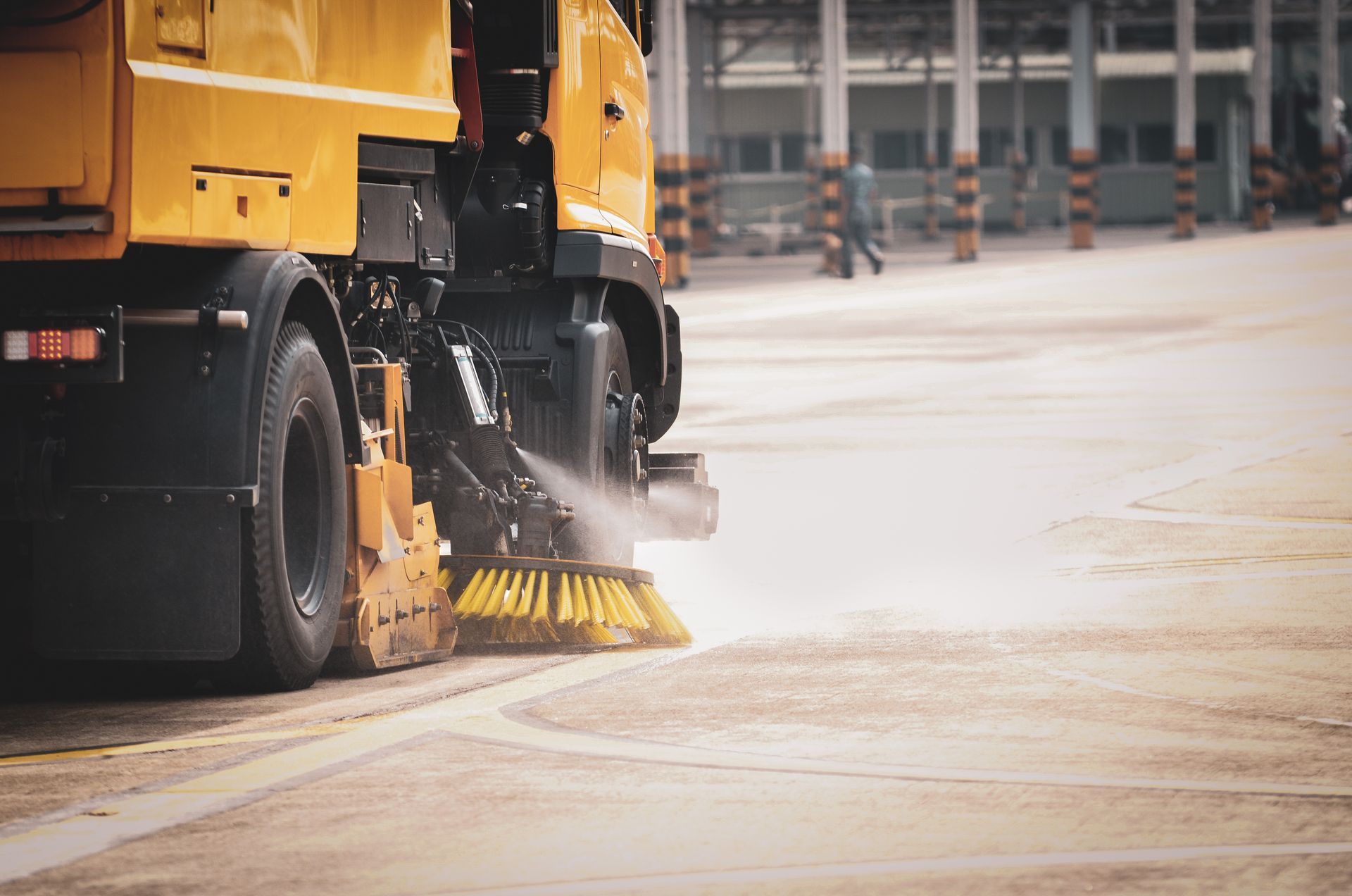 Street sweeper truck cleaning a dirt road. Street sweeper truck cleaning a dirt road.