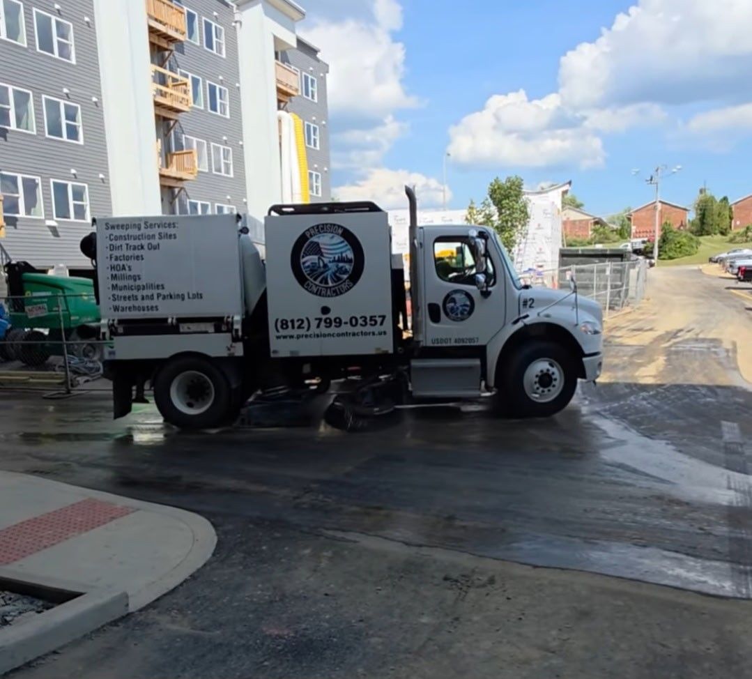 A snowplow clears a city street covered in slush and snow, with parked cars on the side. A snowplow clears a city street covered in slush and snow, with parked cars on the side.