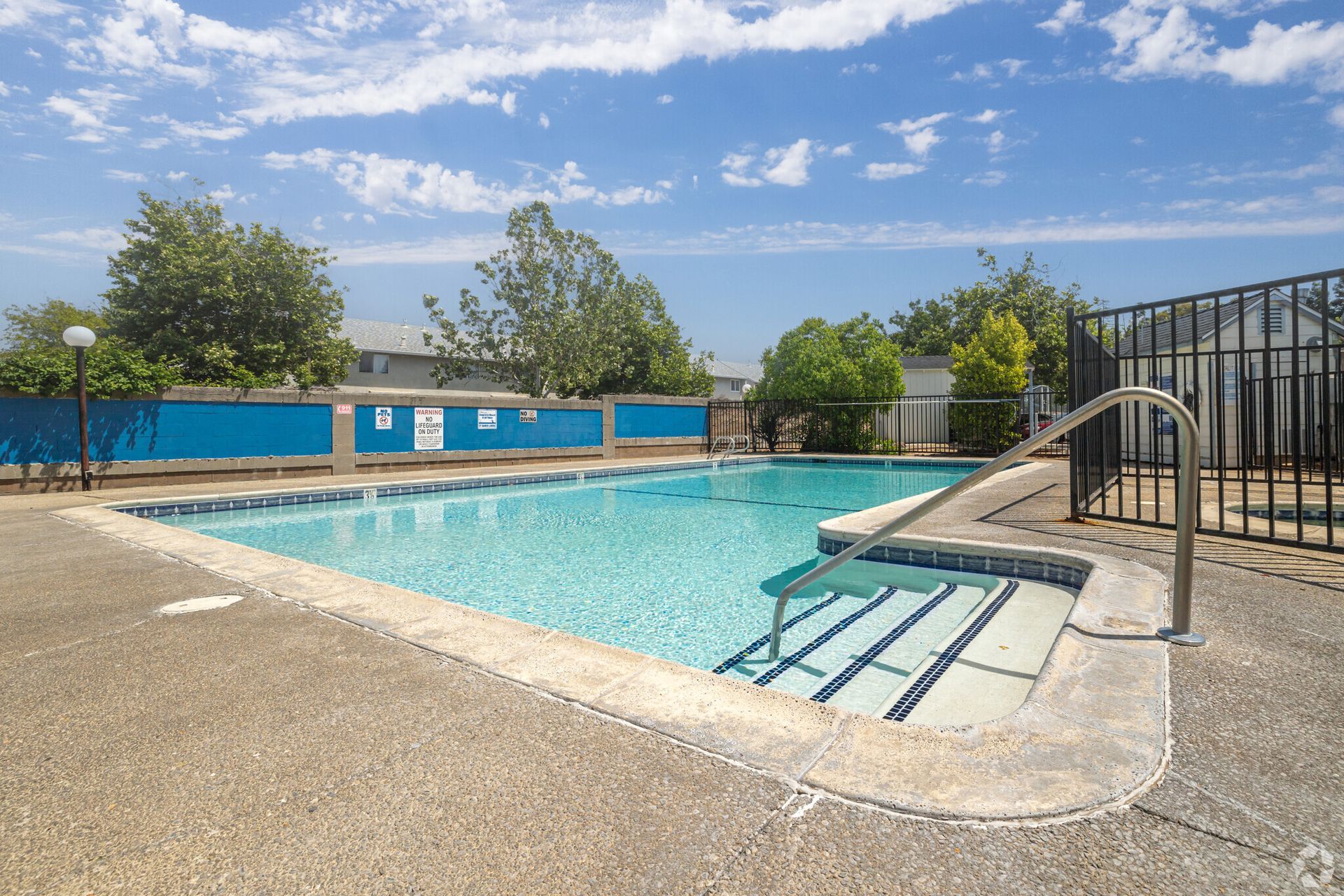 A large swimming pool with stairs leading to it