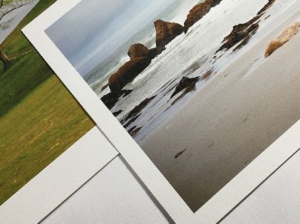 Three pictures of a beach are sitting on a table.