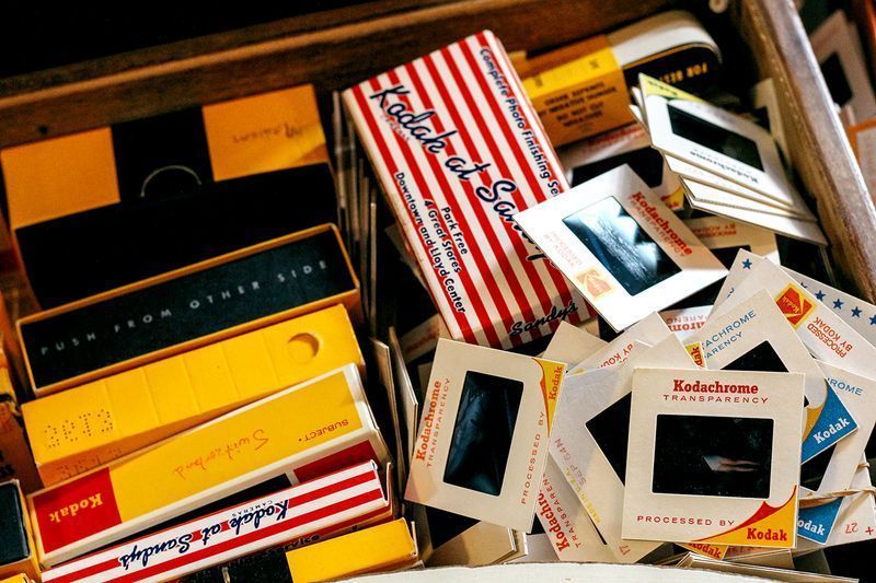 A box of kodak slide film sits on top of a pile of slide film