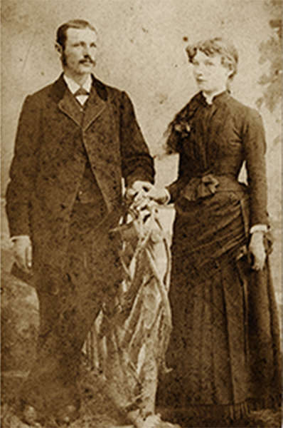 A man and a woman are standing next to each other in a black and white photo.