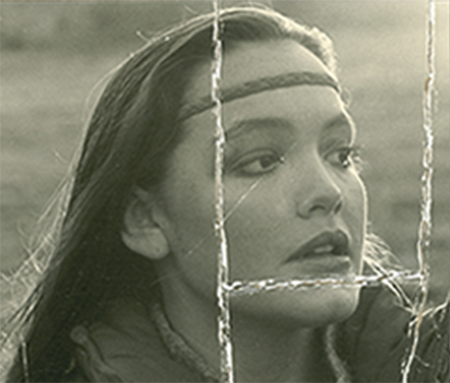 A black and white photo of a woman with a headband on her head