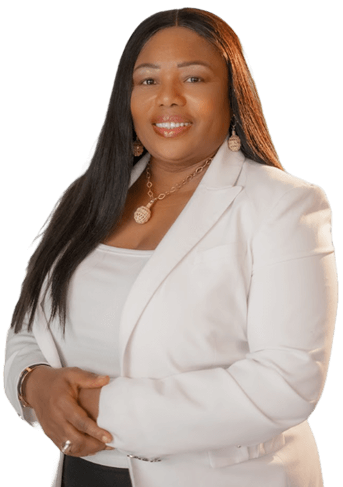 A person smiling, wearing a white blazer and a gold necklace, standing against a white background.