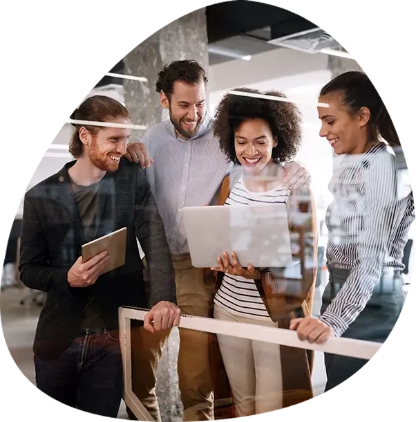 A group of people are looking at a laptop and a tablet.