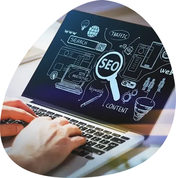 A person is typing on a laptop with a screen that says seo