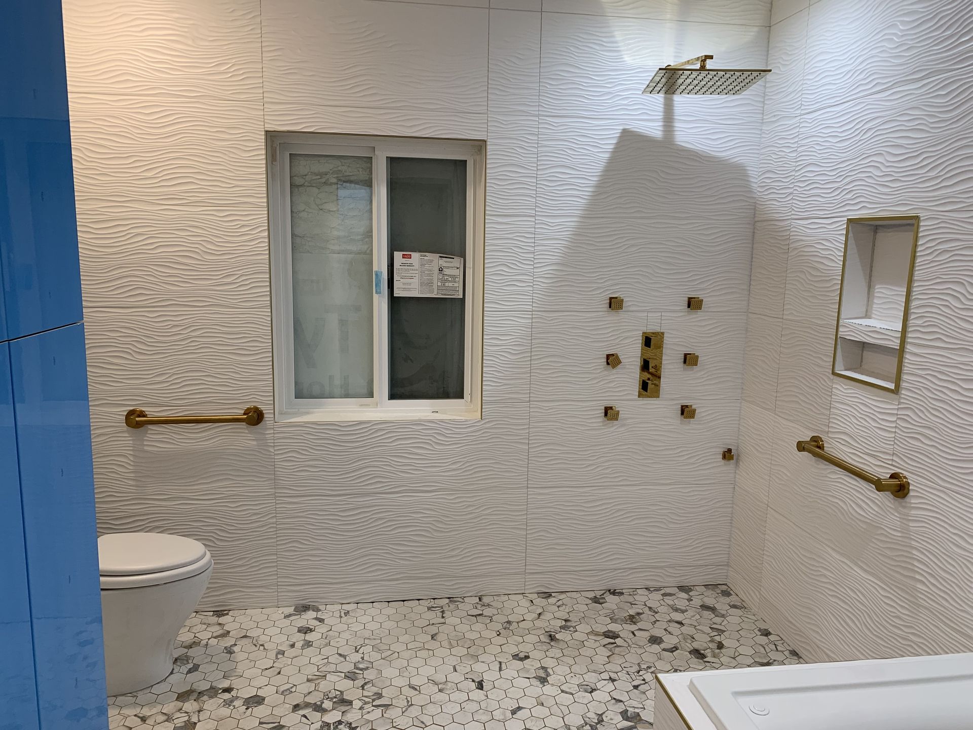 A bathroom with a toilet , shower , and window.