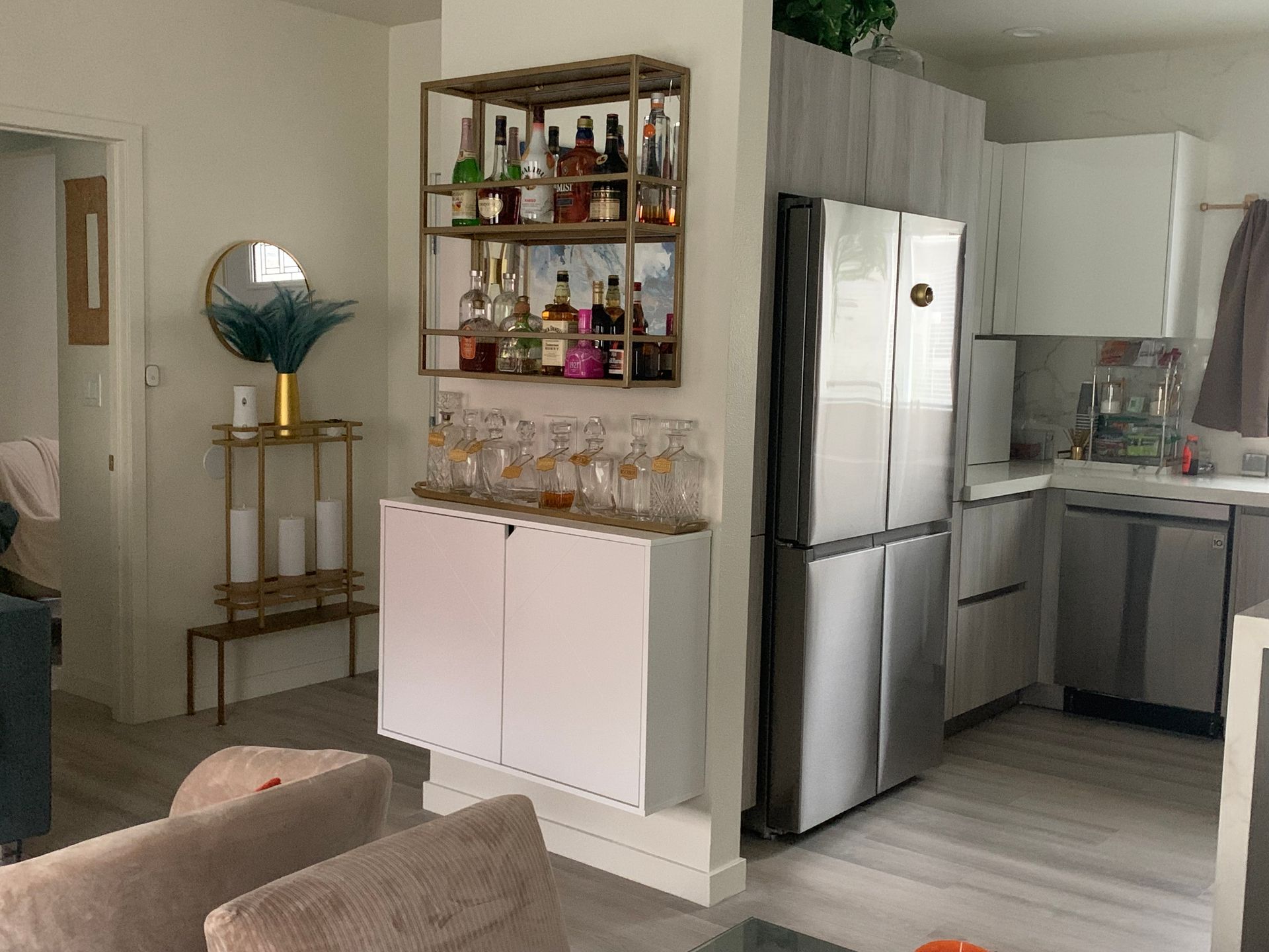 A kitchen with white cabinets and a large island in the middle
