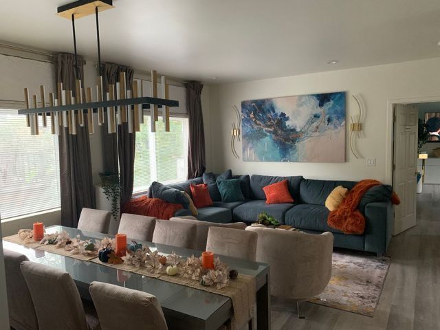 A kitchen with stainless steel appliances and black cabinets.