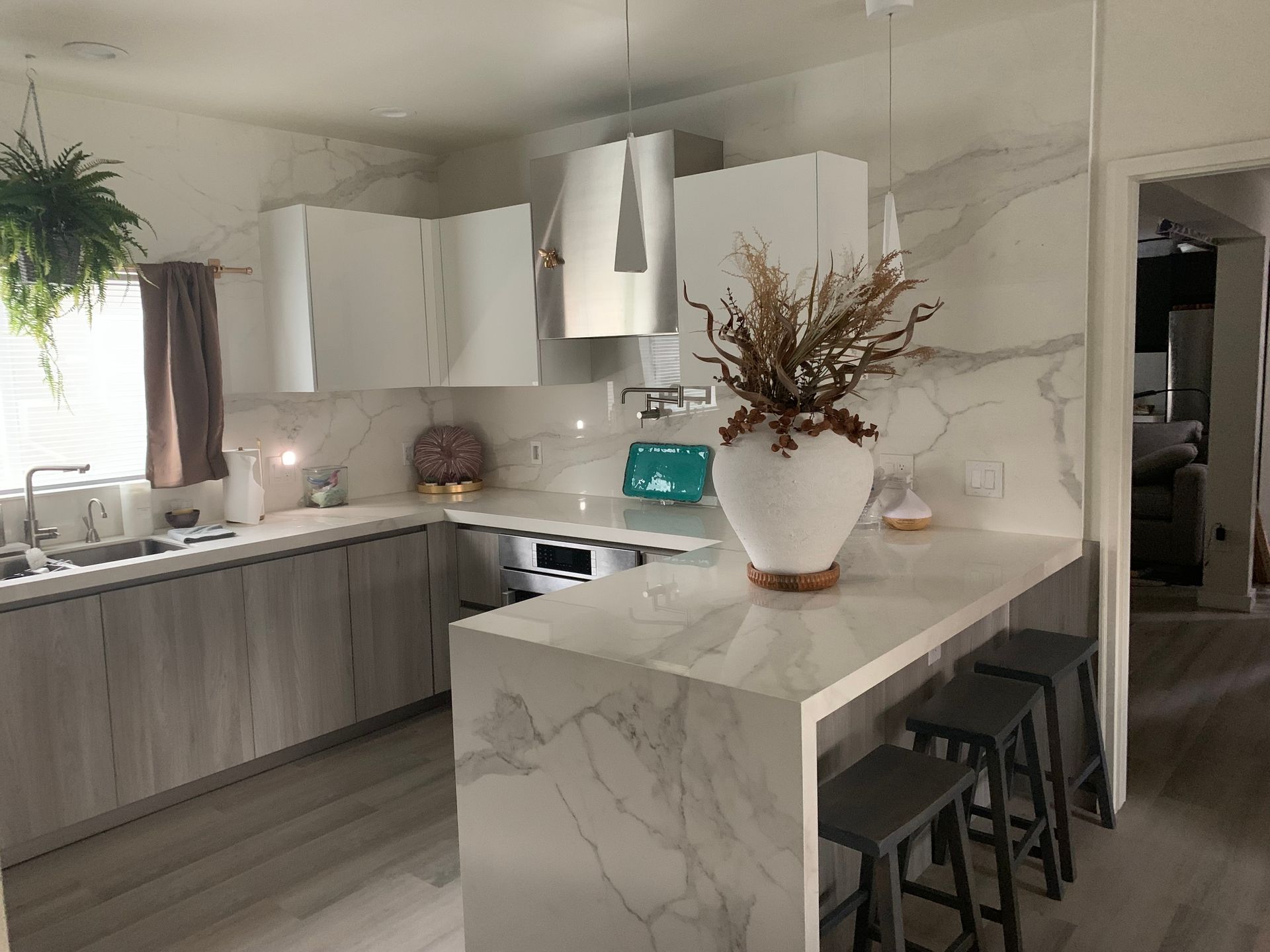 A kitchen under construction with stainless steel appliances and white cabinets.