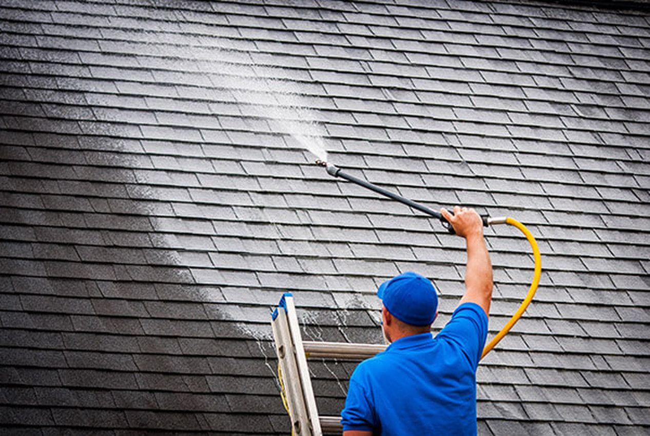 A man is painting a wall with a brush.