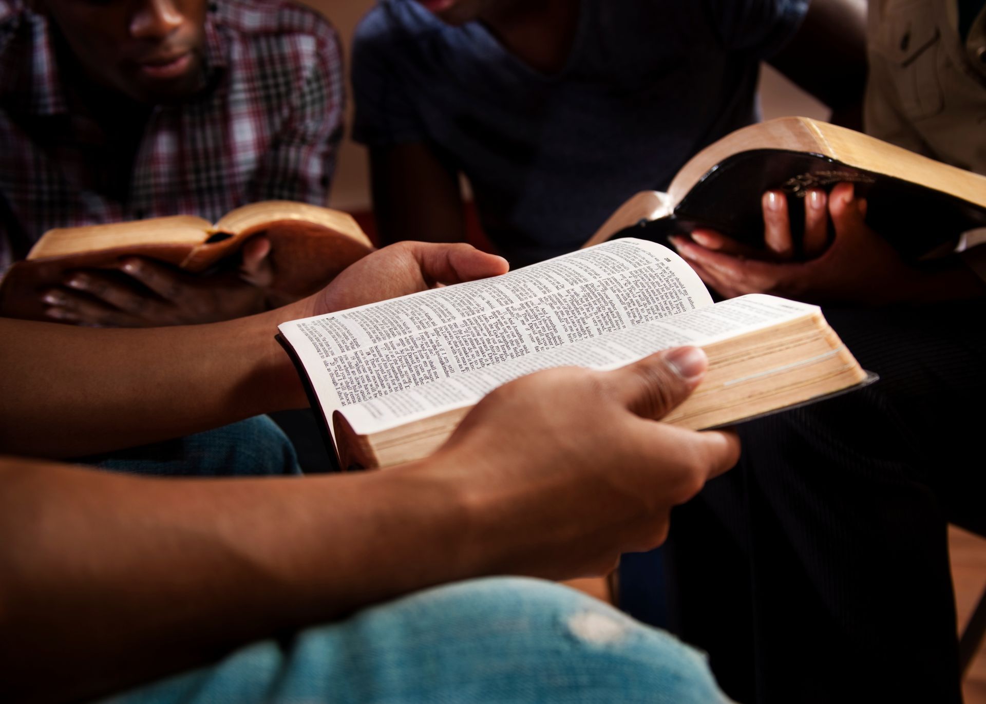 A group of people are reading the bible together