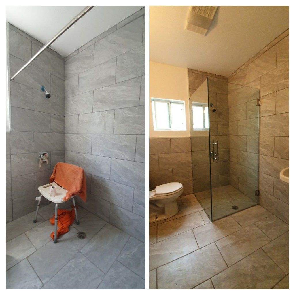 Accessible bathroom with gray tile. Shower with seat, toilet, and glass shower door.