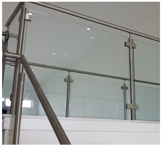 Glass and metal railing on a staircase, with stainless steel posts and handrails.