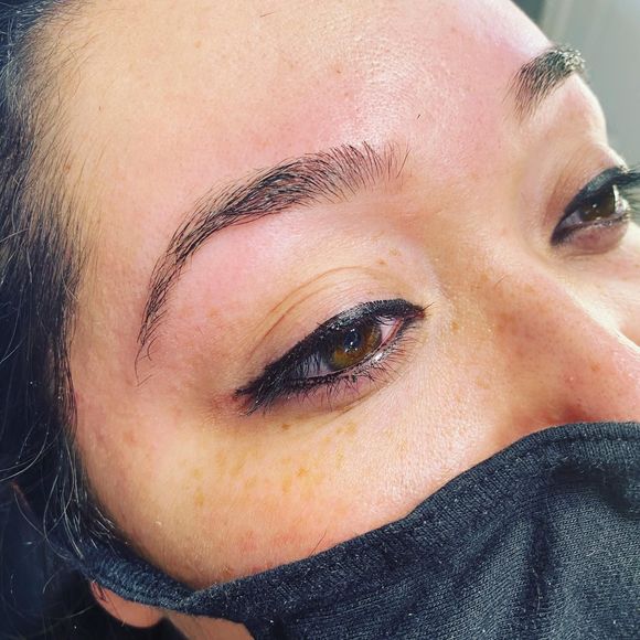 A close up of a woman 's face with a black mask on.