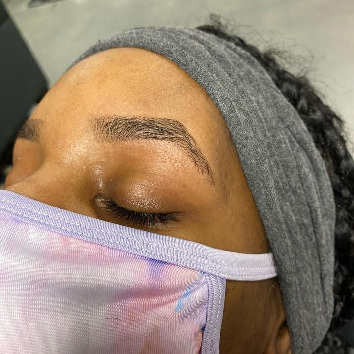 A close up of a woman wearing a mask and a headband.
