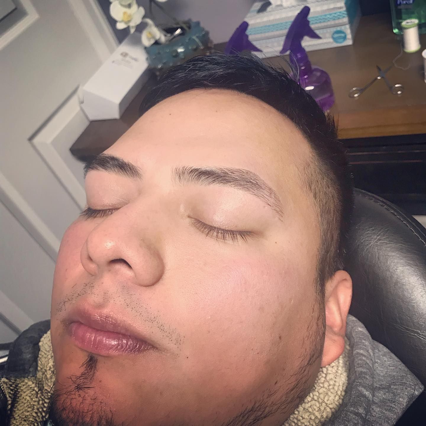 A man is sleeping in a chair with his eyes closed