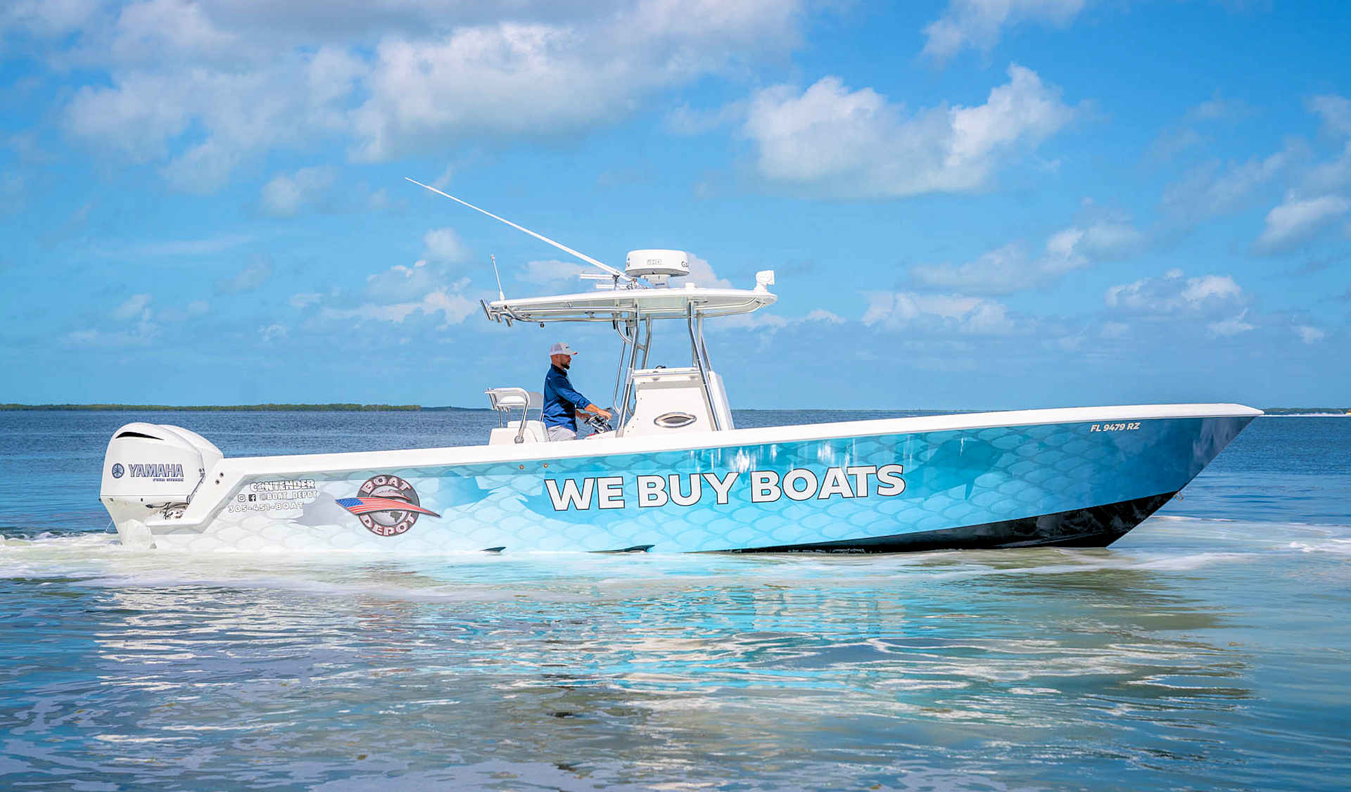 A blue and white boat is floating on top of a body of water.