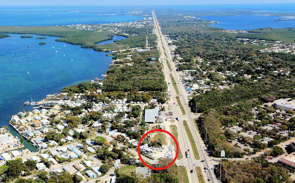 An aerial view of a city with a red circle around a building.