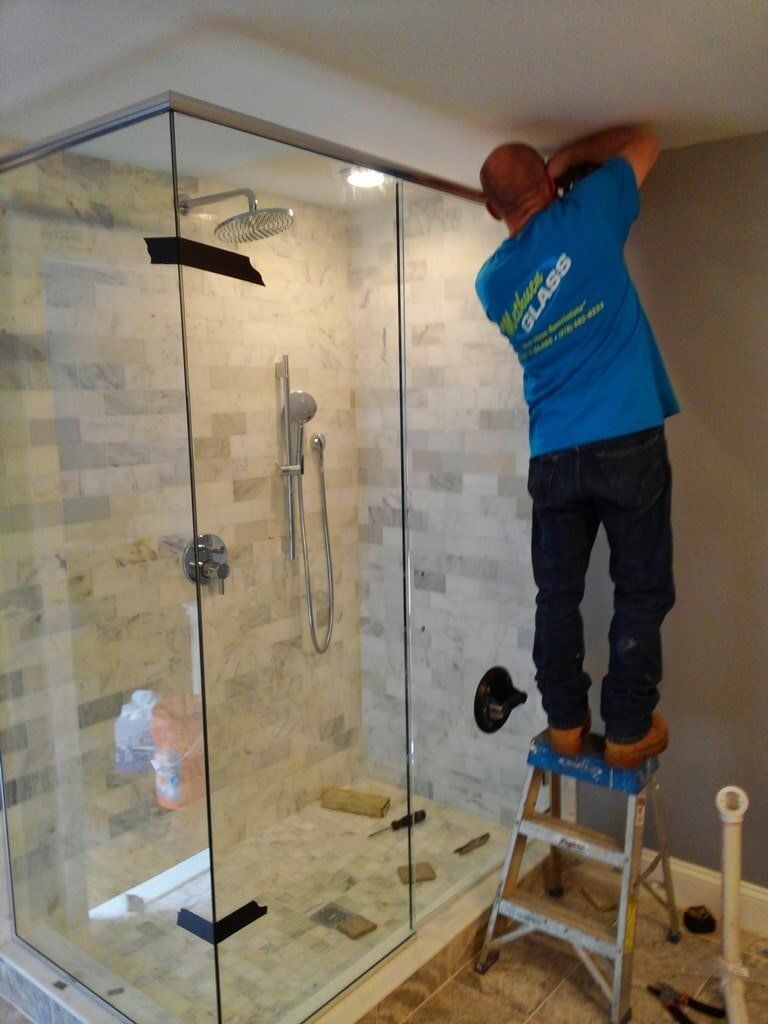 Person Installing a Glass Shower Door — Methuen, MA — Methuen Glass 2