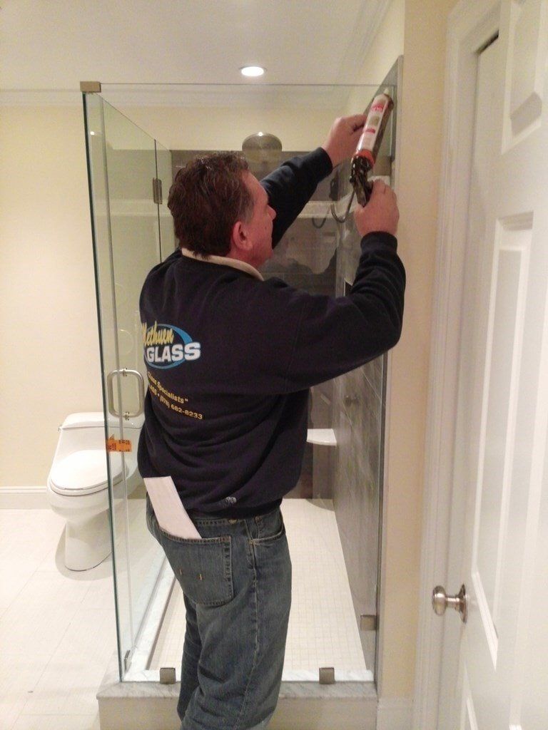 A Man Installing New Shower Doors — Methuen, MA — Methuen Glass 2