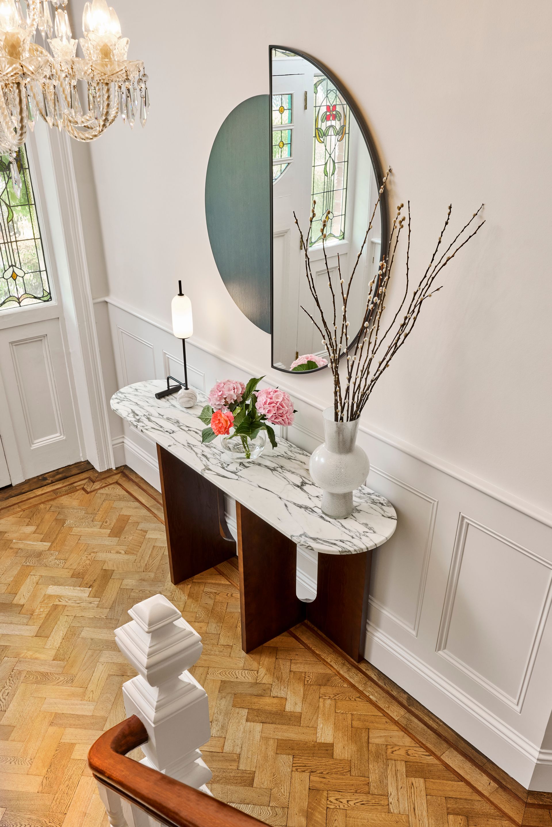 Ballsbride hall decor looking from the upper stairs towards the hall door and custom marble console table.