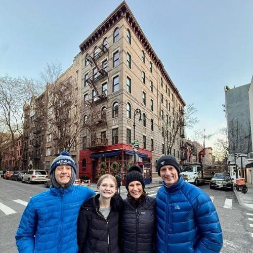 Tour guests standing in front of the Friends apartment building in Greenwich Village, NYC