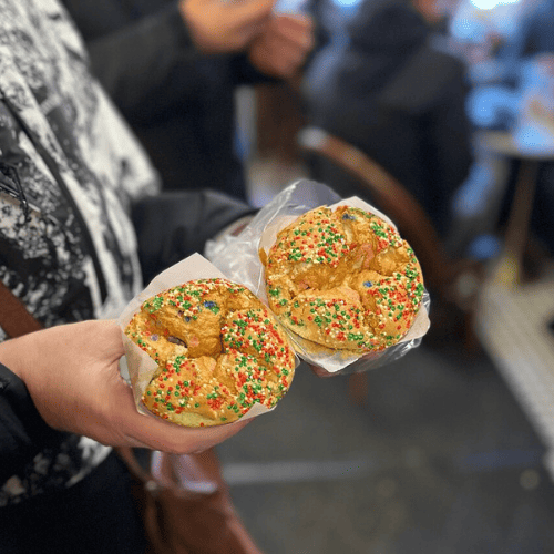 Guest holding a Hong Kong sponge cake from Spongies Cafe in Chinatown, NYC