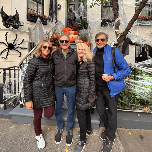 Tour guests standing in front of a decorated Upper East Side brownstone with Halloween decorations in NYC