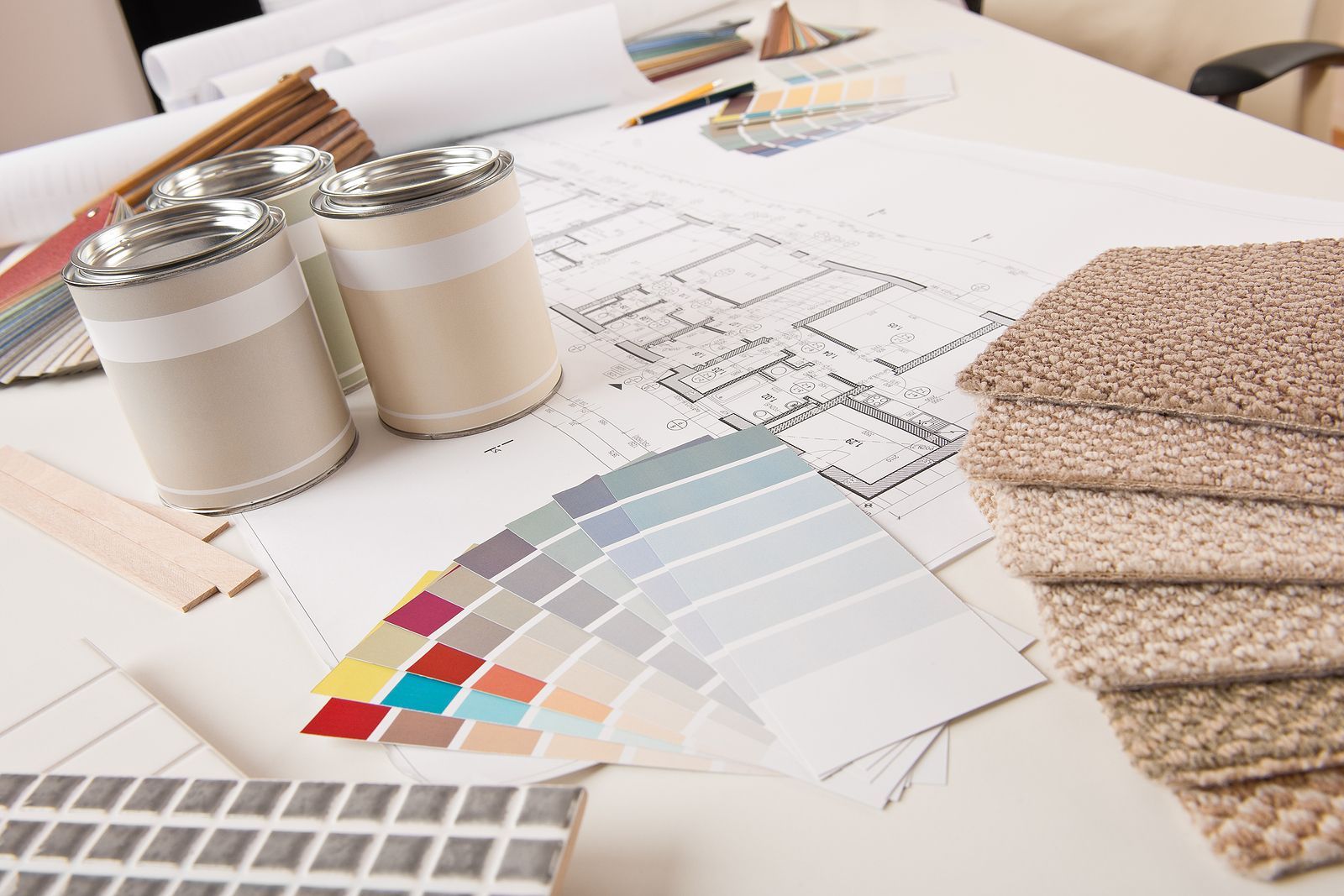 A table with a bunch of samples of carpet and paint on it.