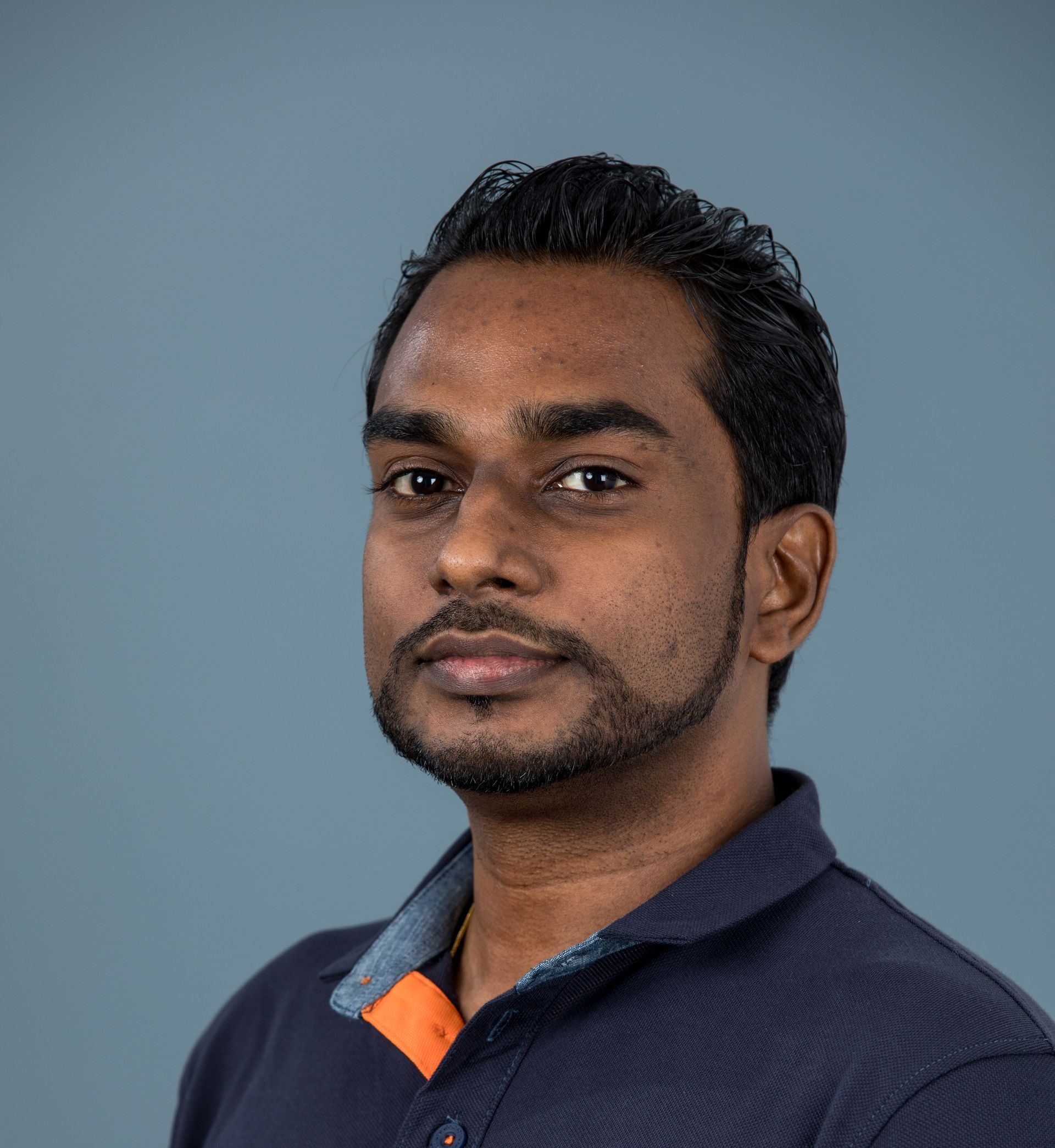 A photo of Buddhika looking at the camera.