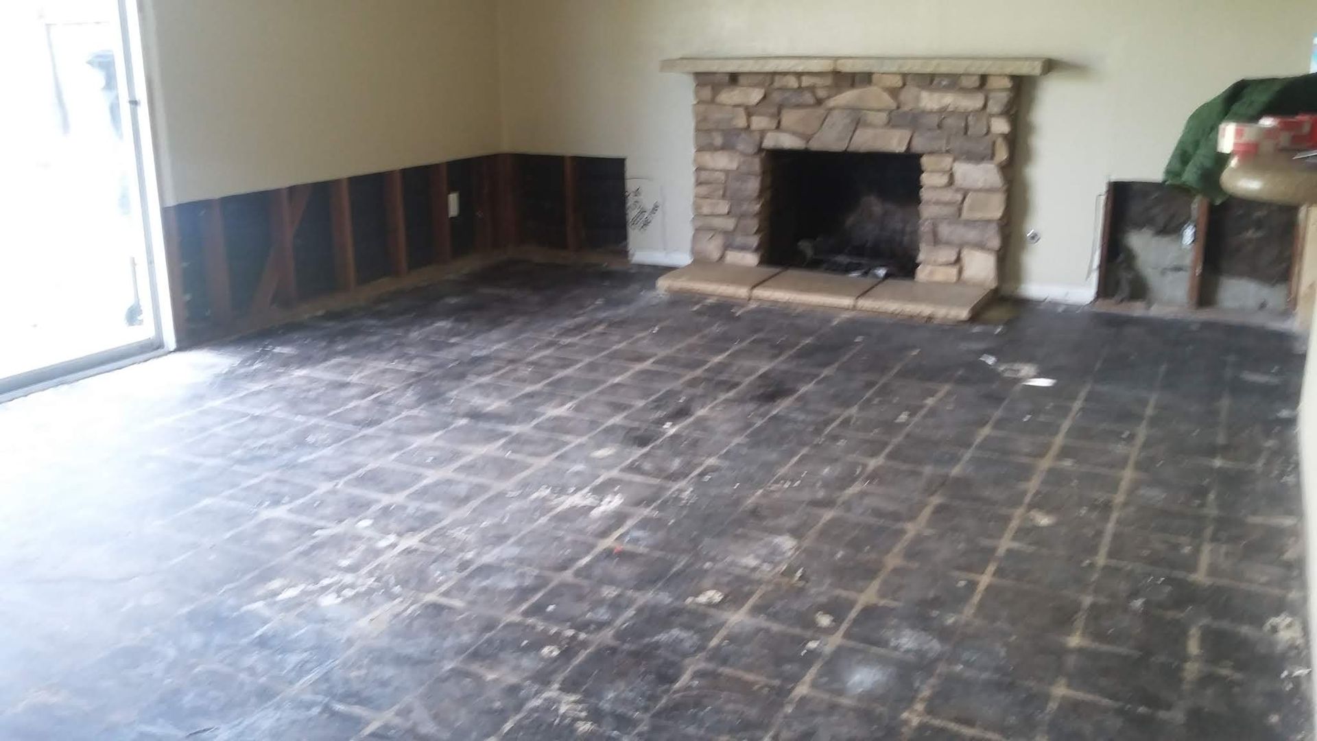A living room with a fireplace and a sliding glass door