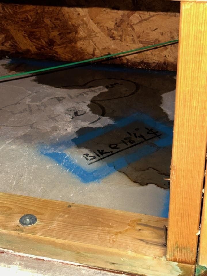 A close up of a concrete floor in a room with a wooden frame.