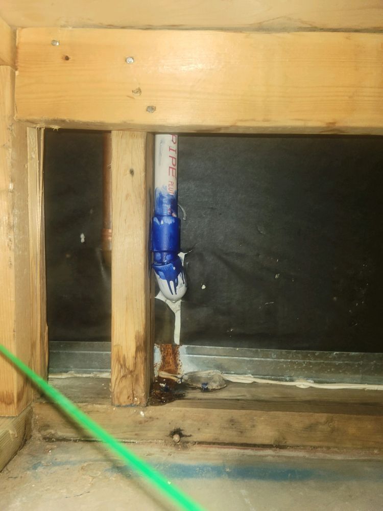 A blue pipe is visible through a hole in a wall