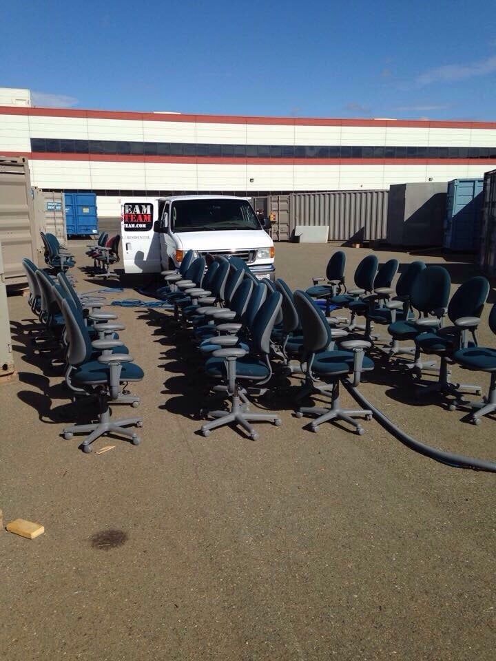 A bunch of chairs are lined up in a parking lot