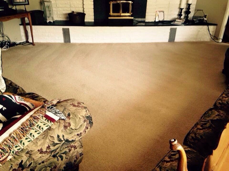 A living room with a couch a chair and a fireplace