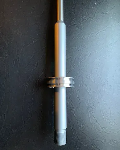 a metal pole with a ring on it is sitting on a black table .